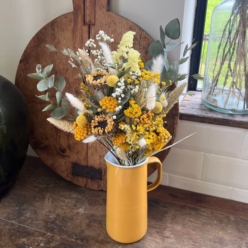 A yellow dried flower bouquet with dried sunflowers