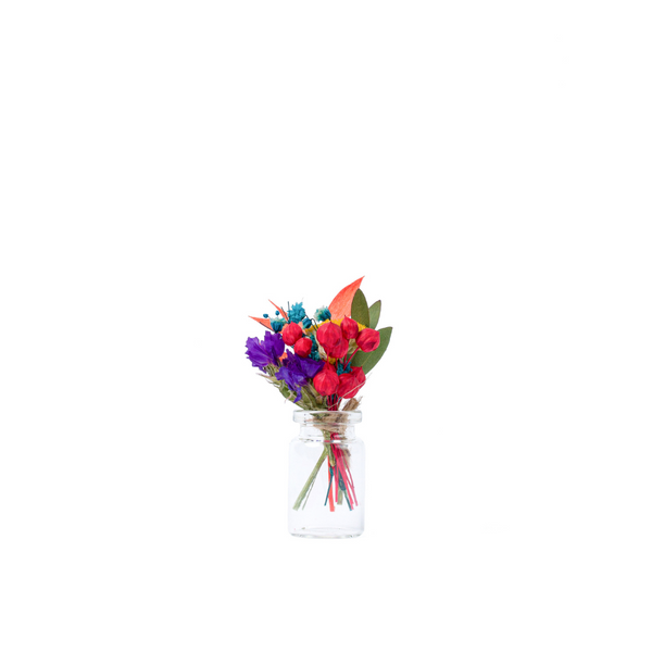 A rainbow dried flower mini bouquet in a mini vase