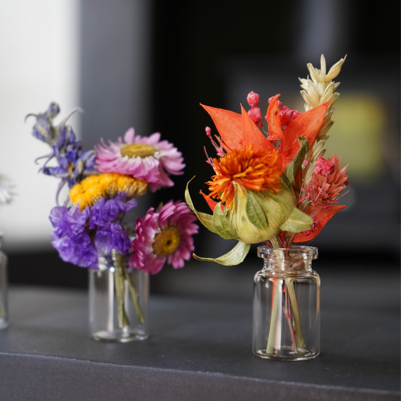 Two dried flower mini bouquets in there mini vases