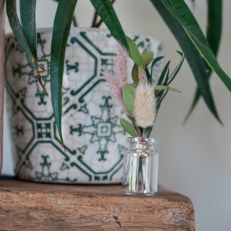 A foliage dried flower mini bouquet in a mini vase