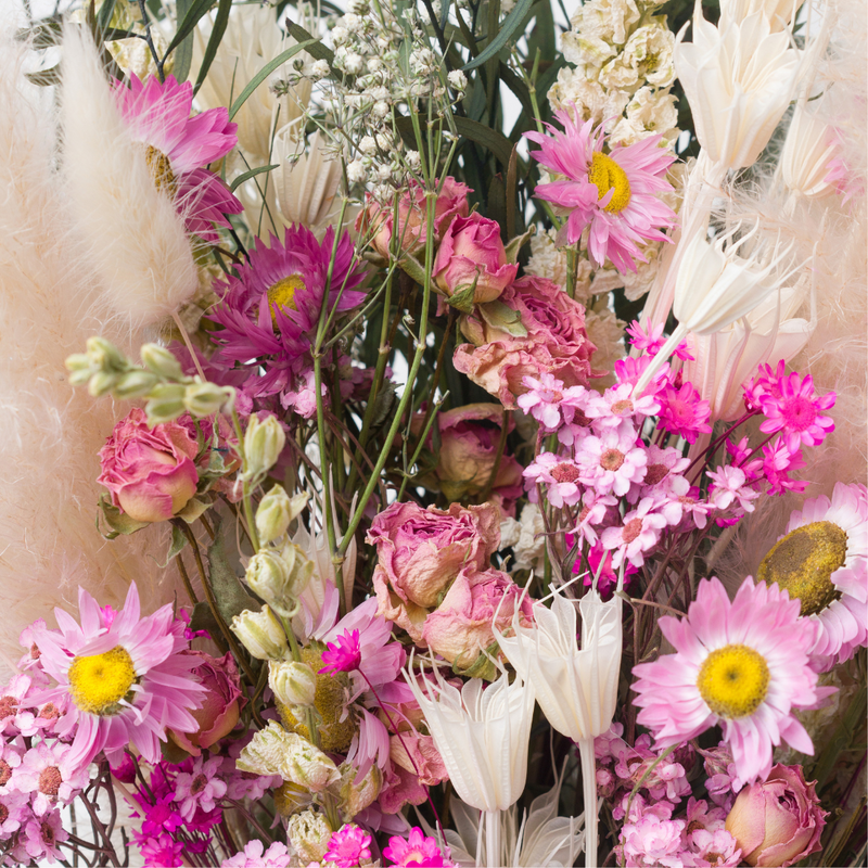 A close up of a pink dried flower bouquet