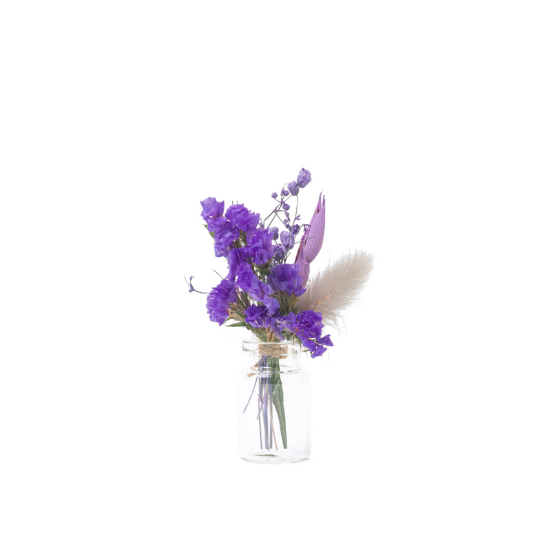A purple mini bouquet made from dried flowers that are not toxic for pets in a mini vase