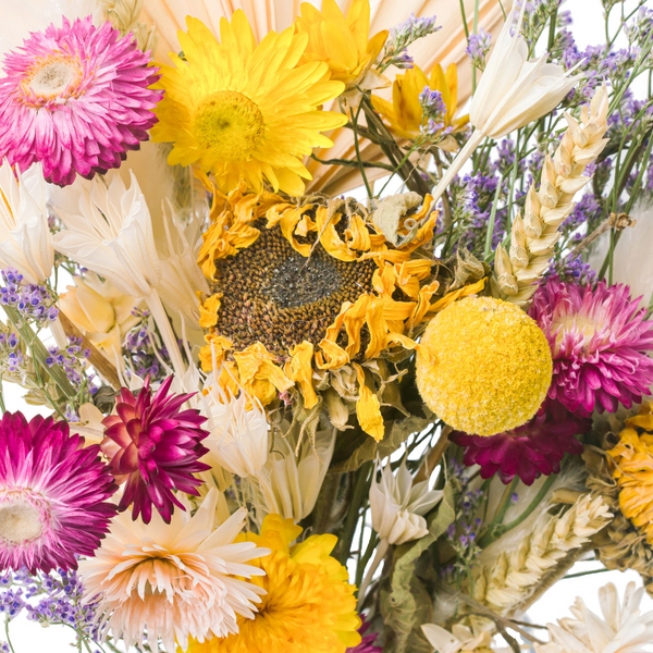 A close up of a yellow spring-inspired dried flower bouquet