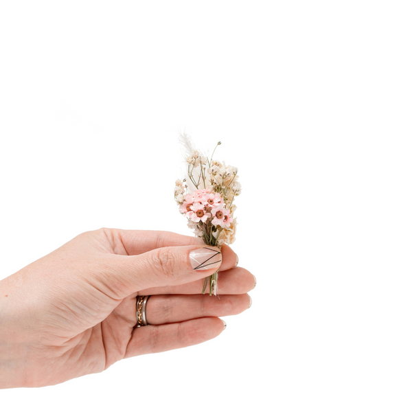 Pink and cream dried flower mini bouquet in a hand