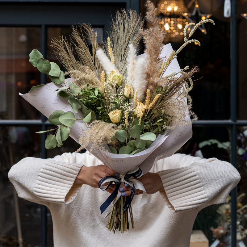 A green and cream dried flower bouquet