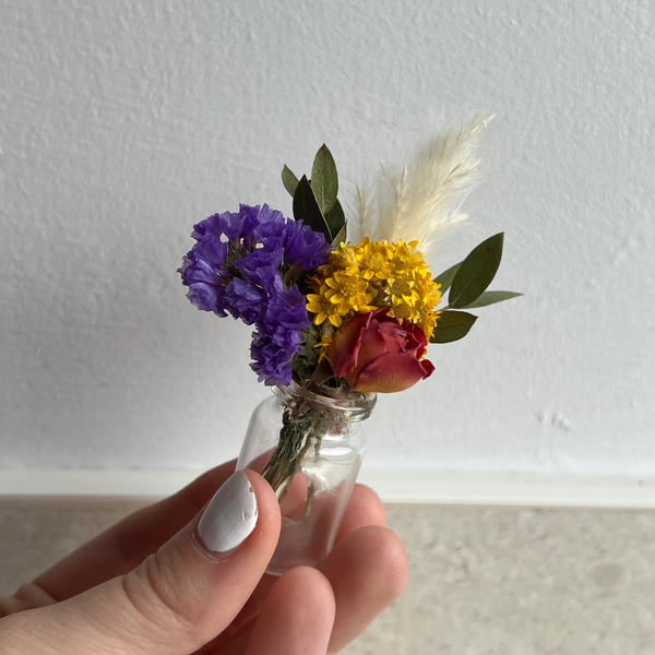 A colourful dried flower mini bouquet in a mini vase