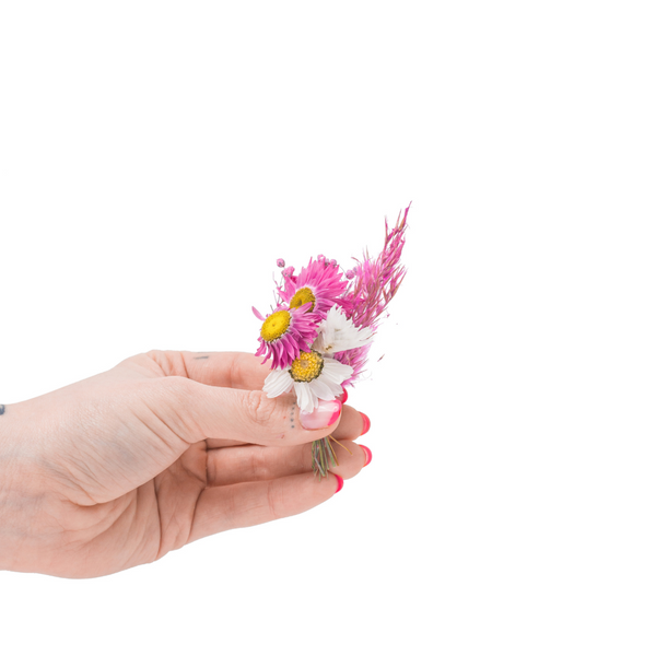 A pink mini bouquet made from dried flowers that are not toxic for pets in a mini vase