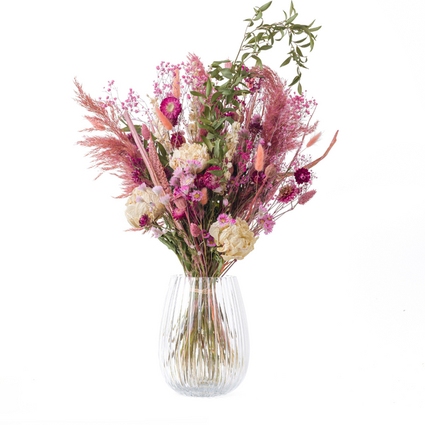 A pink dried flower bouquet with dried peonies