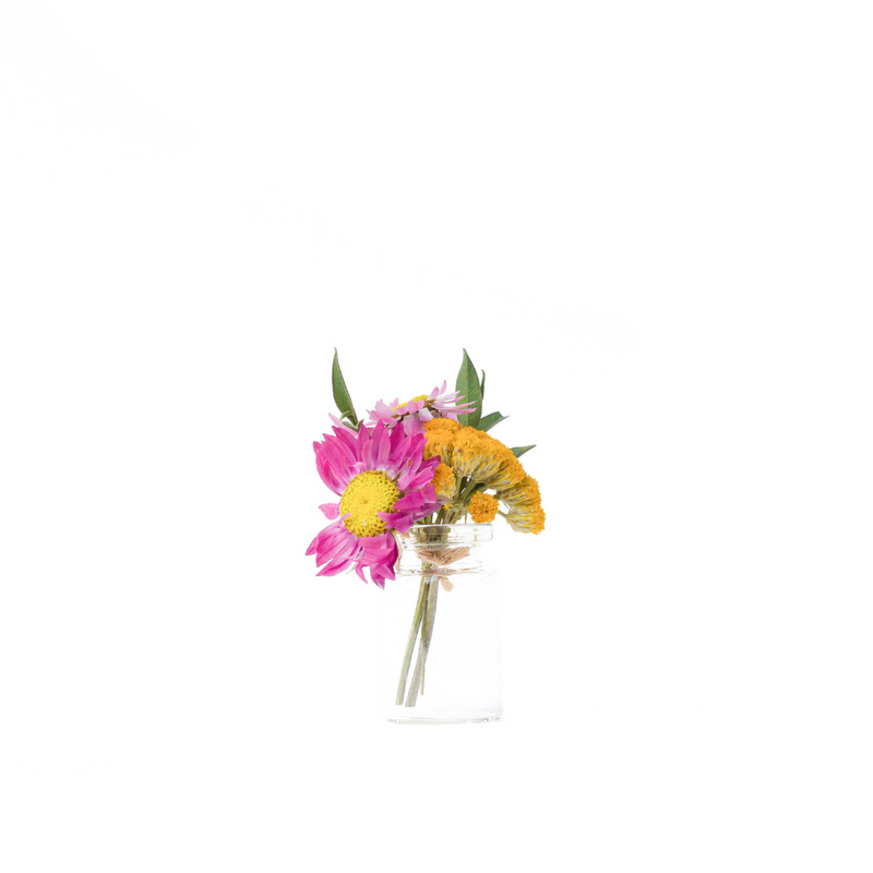 A pink and yellow dried flower mini bouquet in a mini vase