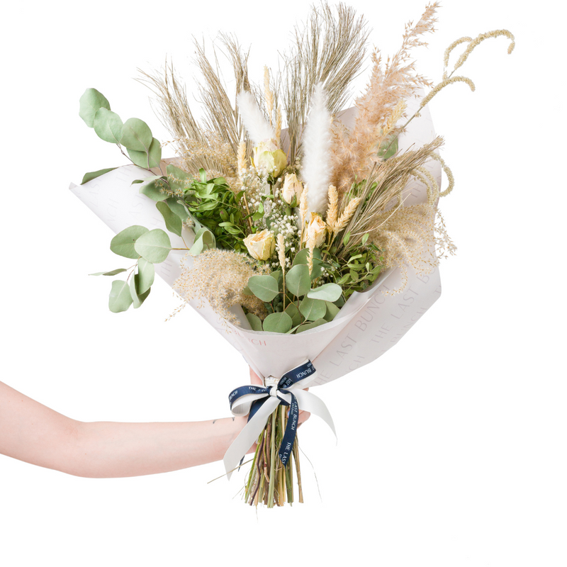 A green and cream dried flower bouquet
