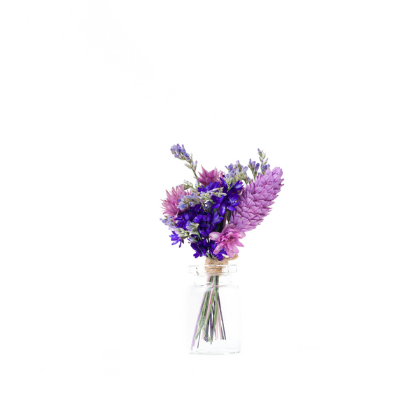 A purple dried flower mini bouquet in a mini vase