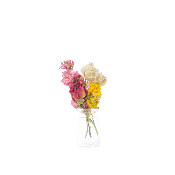 A bright and colourful mini bouquet in a mini vase