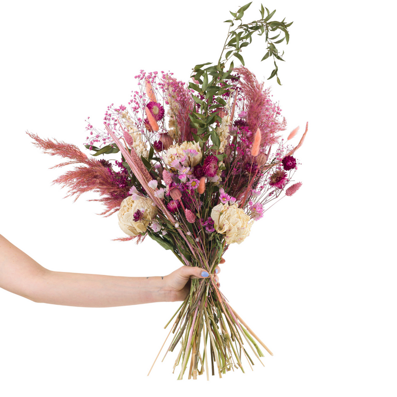 A pink dried flower bouquet with dried peonies