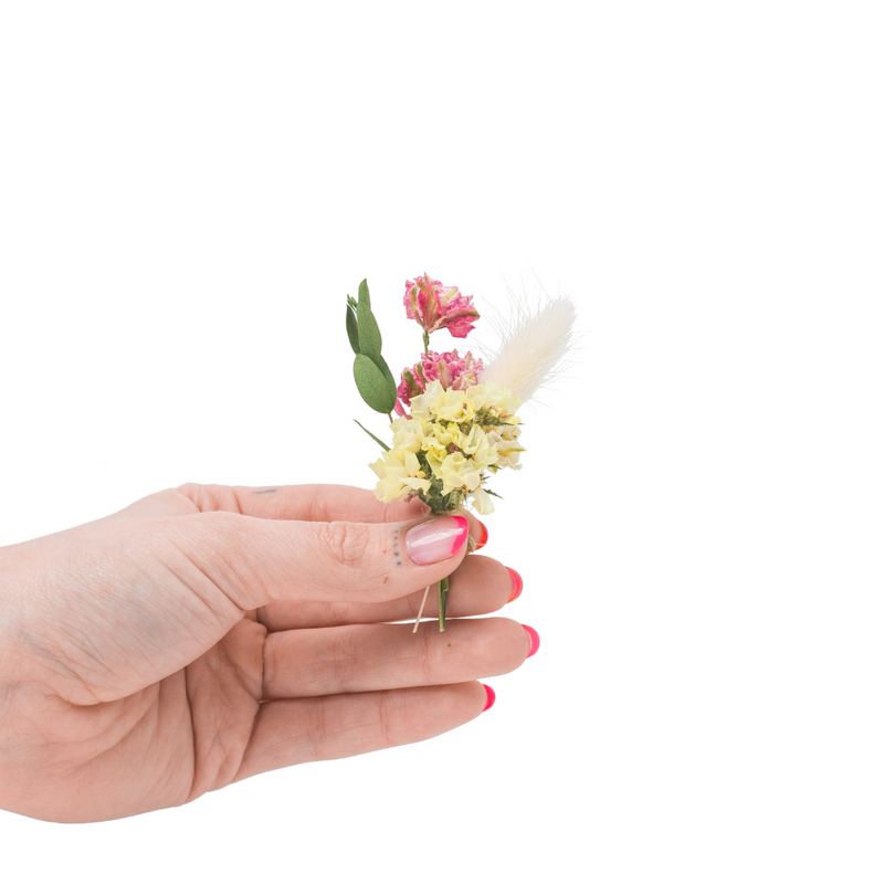 A colourful dried flower mini bouquet in a hand