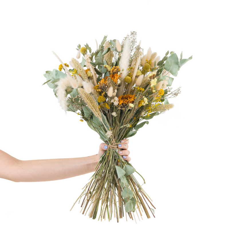 A yellow dried flower bouquet with dried sunflowers