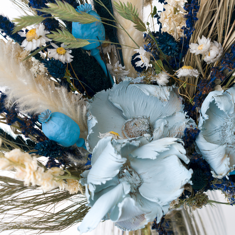 A close up of a blue dried flower bouquet