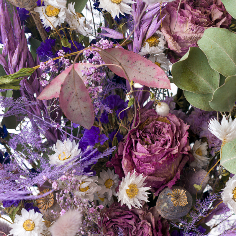 A close up of a purple dried flower bouquet