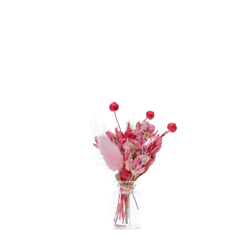 A pink and red dried flower mini bouquet in a mini vase