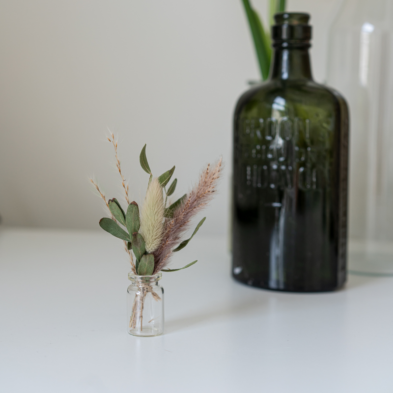 A foliage dried flower mini bouquet in a mini vase
