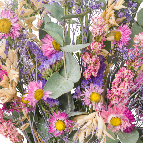 A close up of a pink and purple dried flower bouquet